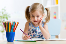 Cute Little Preschooler Child Drawing At Home