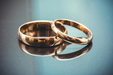 Golden Wedding Rings Isolated On Blue Background