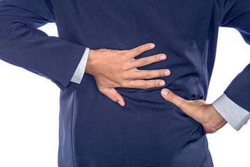 Backache concept bending over in pain with hands holding lower b