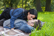 young woman seduces her boyfriend with kisses in the park