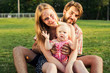 © kurapatka - young happy family having fun outdoors in park