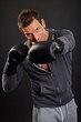 © petrdlouhy - Handsome man showing strike with boxing gloves