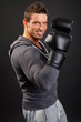 © petrdlouhy - Portrait of smiling man with boxer gloves