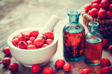 Wall Mural - mortar of hawthorn berries, two tincture bottles and thorn apple