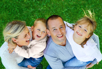 Happy family on a background of grass top view