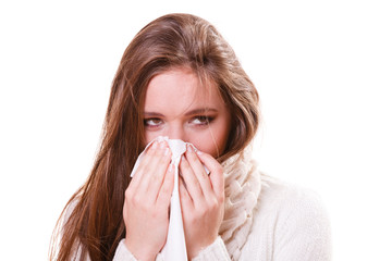 Sick woman girl with fever sneezing in tissue