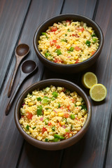 Wall Mural - Vegetarian couscous salad made with bell pepper, tomato, cucumber, red onion and sweet corn kernels, photographed with natural light (Selective Focus, Focus in the middle of the first salad)