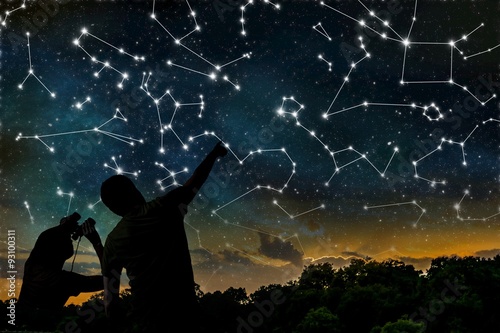 Astrology concept. Constellations on night sky. Silhouettes of astrologers ob...