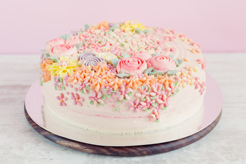 Wall Mural - Pastel pink cake decorated with cream flowers