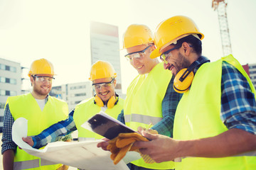 Canvas Print - group of builders with tablet pc and blueprint