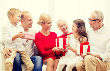 Poster - smiling family with gifts at home