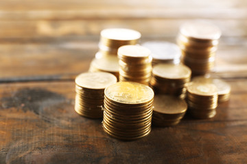 Poster - Stack of coins on wooden background