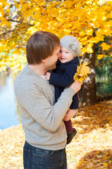 Young happy father with daughter in autumn park