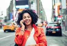 American Woman Making A Phone Call In Time Square, New York. Urban Lifestyle Concept