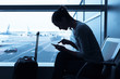 © kieferpix - Woman using internet in the airport terminal