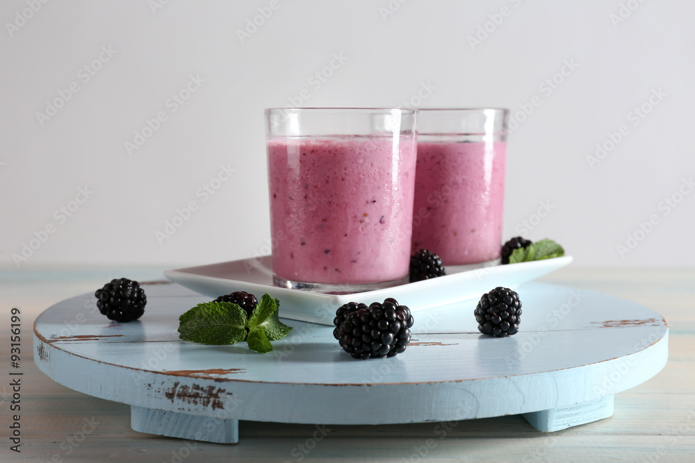 Delicious berry smoothie with blackberries on wooden table close up