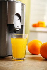 Poster - Juicer and orange juice on kitchen table