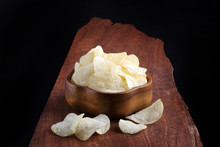 Crispy Potato Chips In Wooden Bowl On Wooden Tray And Black Back