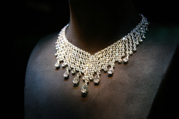 Necklace made of white gold with diamonds on a stand.