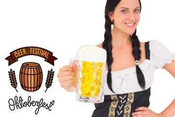 Composite image of pretty oktoberfest girl holding beer tankard