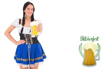 Composite image of pretty oktoberfest girl holding beer tankard