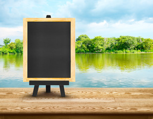 Poster - Empty wood table with lagoon at forest and blue sky at backgroun