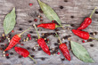 dry chili pepper and allspice bay leaf on a wooden table