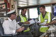 © Westend61 - Ship crew and captain on bridge