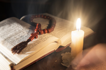 holy book and cross on a wooden background