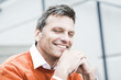 © Westend61 - Businessman wearing orange sweater, portrait