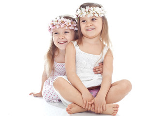 Beautiful sisters are posing in studio with bunch