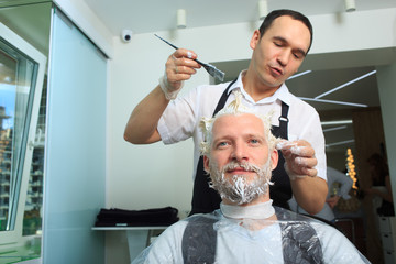 man repaint the hair in a beauty salon