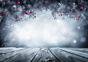 Wall Mural - winter background with frost fir branch on vintage table