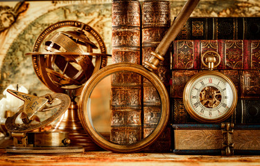 vintage magnifying glass lies on an ancient world map