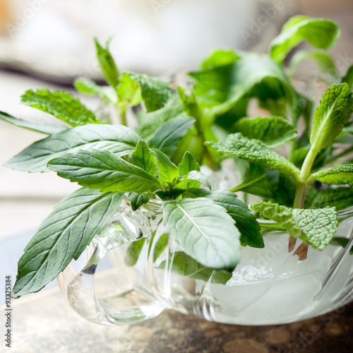 Fototapeta na drzwi i meble Fresh bergamot, mint leaves in a glass cup