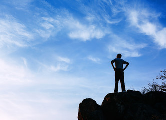 Wall Mural - silhouette of a man at the sunset on the mountain