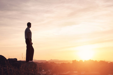Wall Mural - silhouette of a man at the sunset on the mountain