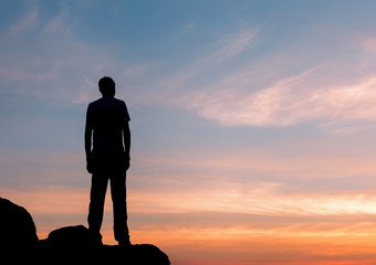 Wall Mural - silhouette of a man at the sunset on the mountain