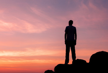 Wall Mural - silhouette of a man at the sunset on the mountain