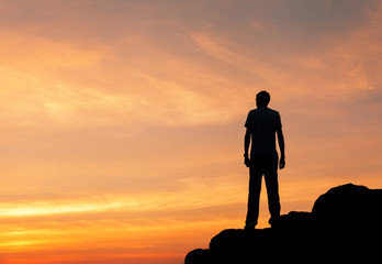 Wall Mural - silhouette of a man at the sunset on the mountain