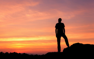 Wall Mural - silhouette of a man at the sunset on the mountain