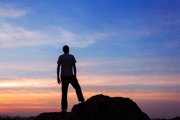 Wall Mural - silhouette of a man at the sunset on the mountain