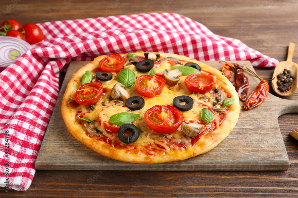 Tasty pizza with vegetables and basil on table close up
