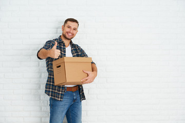 moving to a new apartment. happy man with cardboard boxes