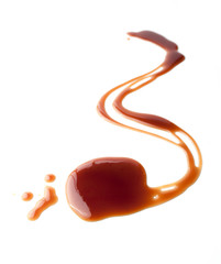 Wall Mural - Sweet caramel sauce on a white background