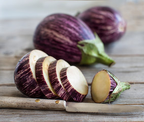 Wall Mural - Fresh Raw striped eggplants and slices with knife