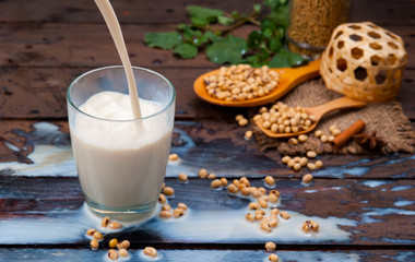 Soy milk splash with beans on wood