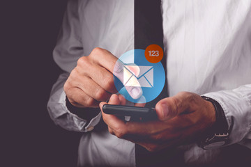 Businessman viewing e-mail on mobile smartphone