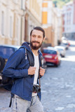 Fototapeta Na ścianę - Attractive bearded guy is making journey across town