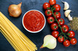 Ingredients for Spaghetti with marinara sauce.  Ready to Cook. On blue background